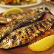 Whole Grilled Sardines, Resting On Fresh Tomato Sauce